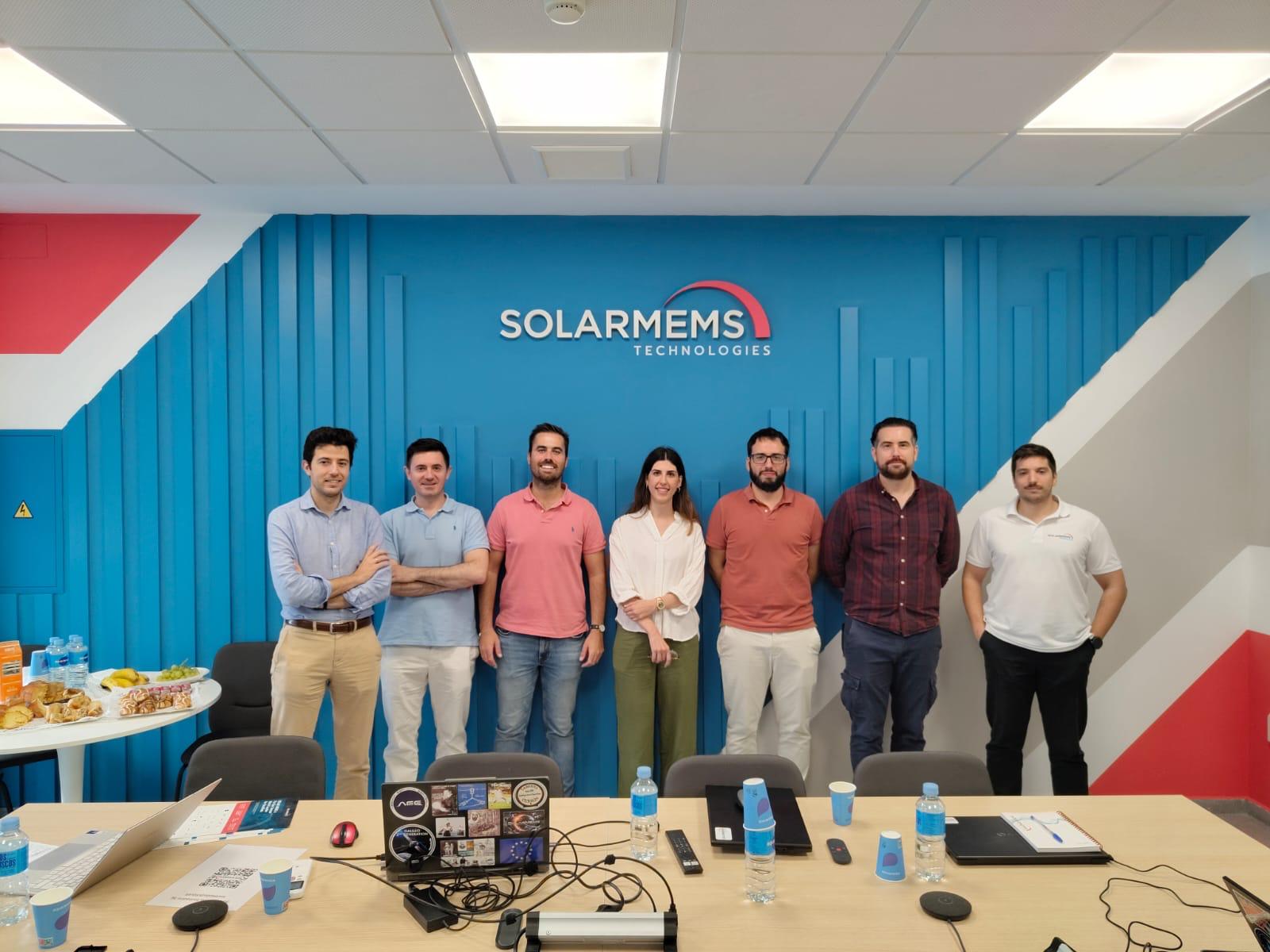 Seven professionals posing at SolarMEMS Technologies office